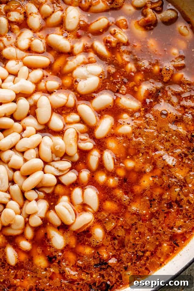 Simmering Beans in the Unique Root Beer Sauce Cannellini beans simmering in the rich root beer sauce.