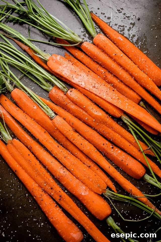 Raw carrots cut in half, lengthwise, showing their vibrant orange color