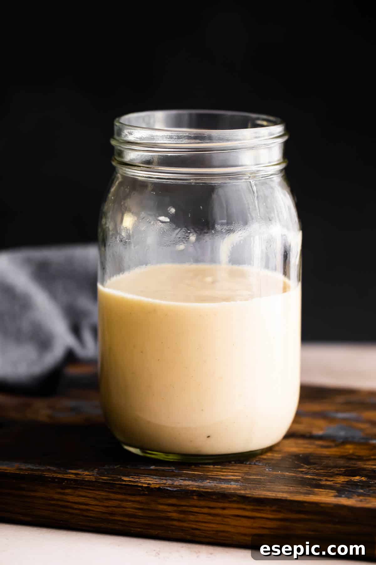 Velvety Creamy Chicken Soup 3 A glass jar, half-filled with the smooth, creamy texture of freshly made homemade cream of chicken, ready for storage.