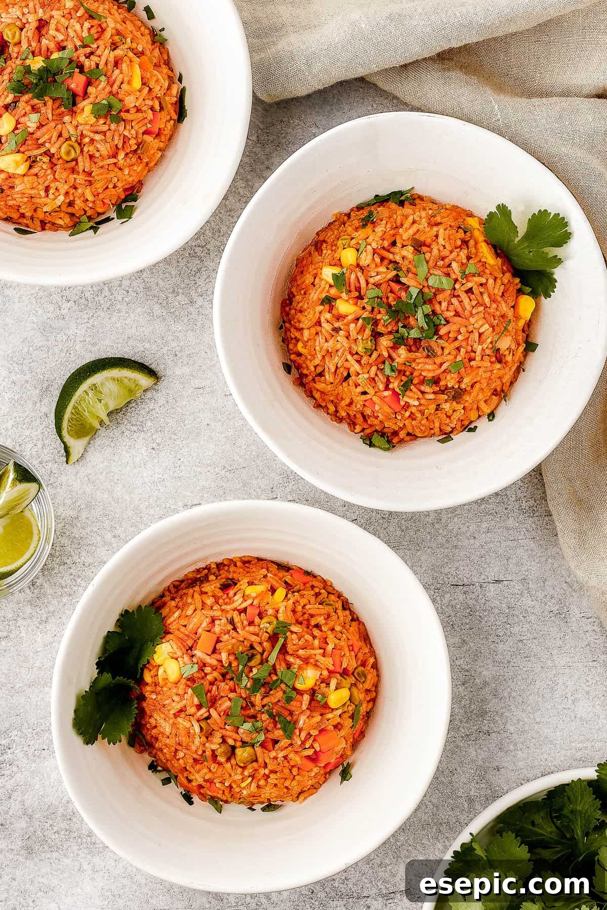 A serving of Mexican rice in a white bowl, garnished with cilantro.