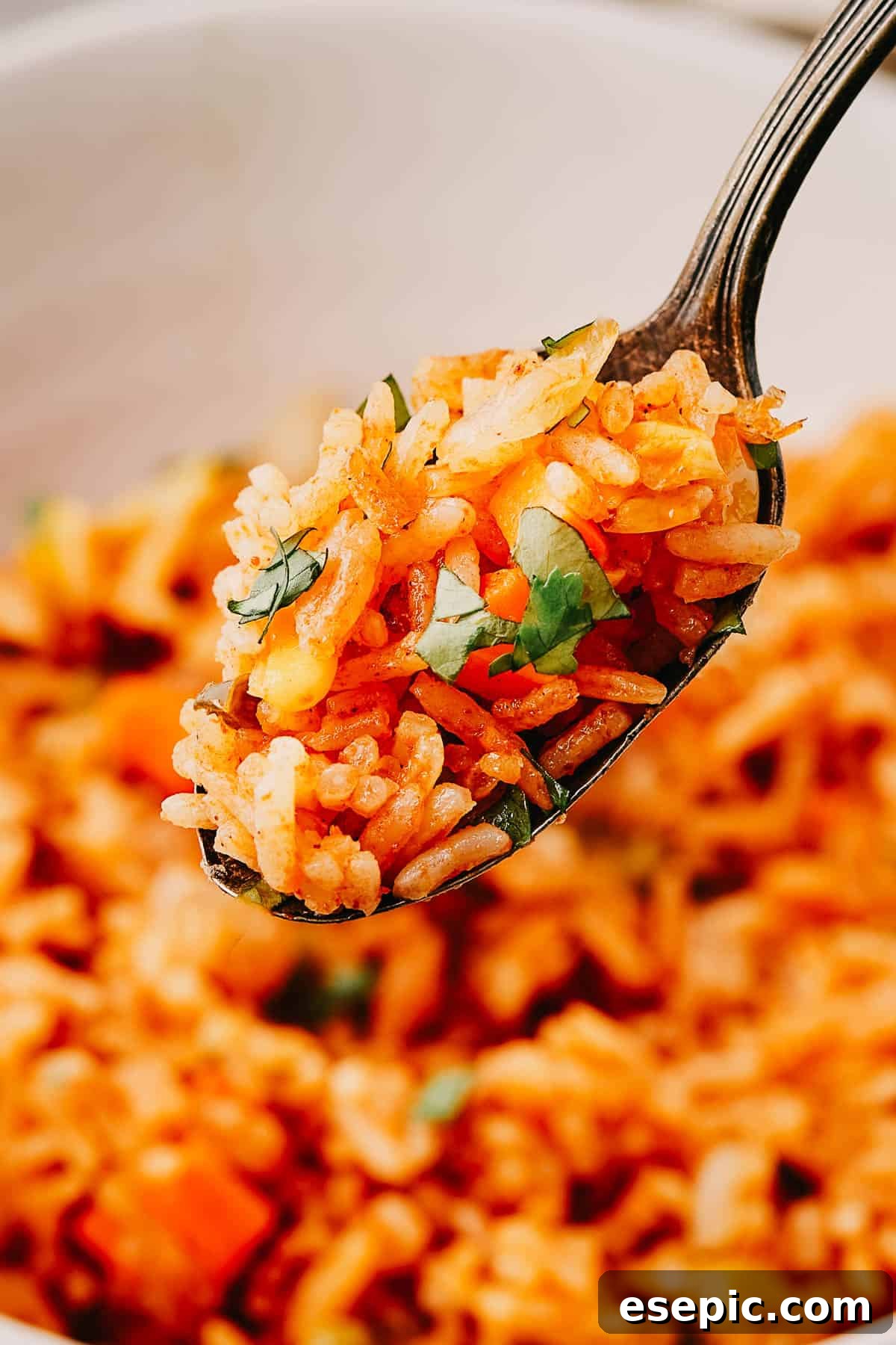 Speedy Instant Pot Mexican Rice 10 A spoon lifting a bite of rice out of a bowl.