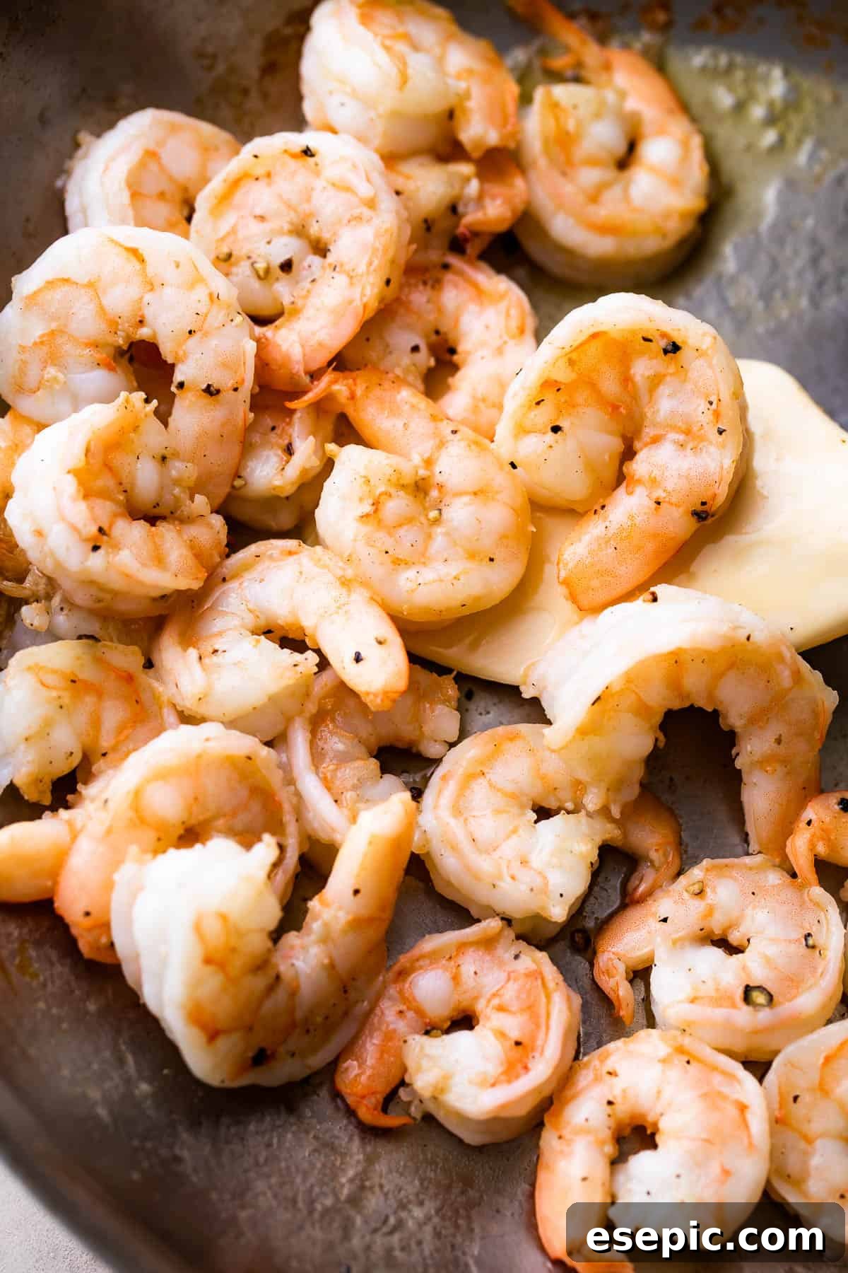 Velvety Parmesan Gnocchi with Succulent Shrimp 4 cooking shrimp in a skillet