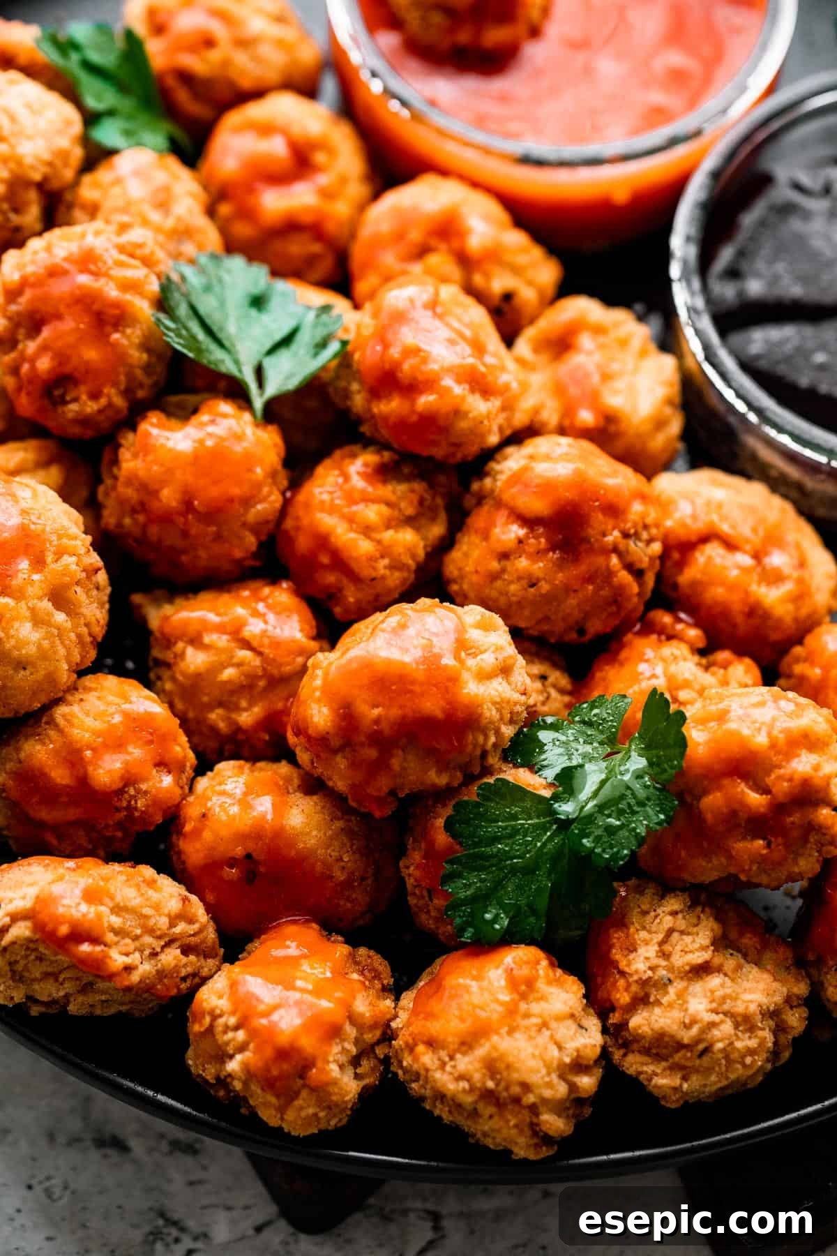 A tantalizing spread of fried popcorn chicken, ready to be enjoyed with accompanying dips and sides.