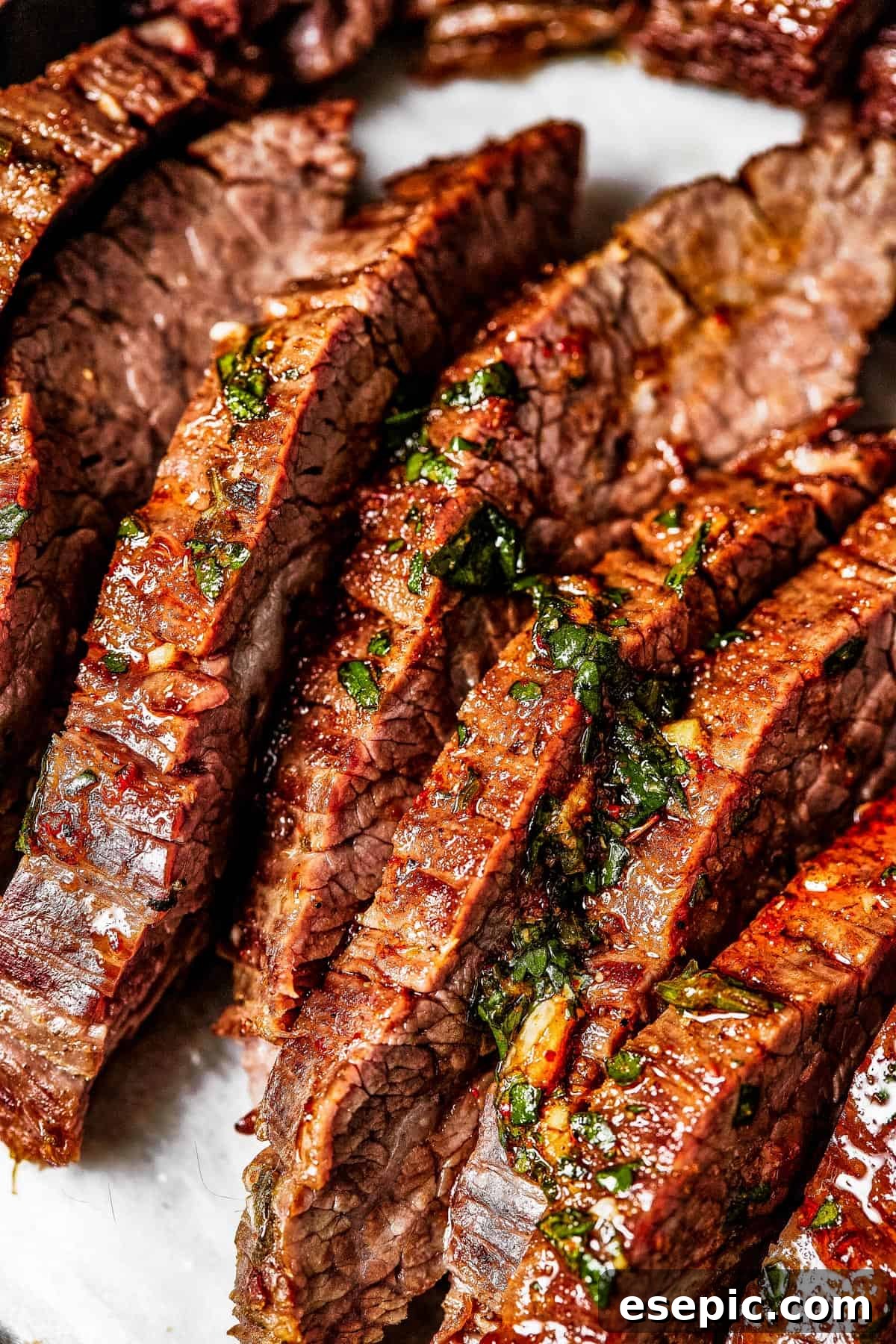 Close-up of finely sliced, juicy carne asada steak, showcasing its tender texture and rich color.