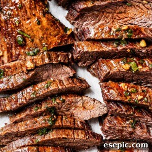 Sliced cooked steak on a cutting board.