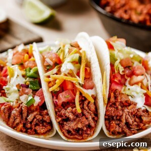 Tacos on a small white plate.