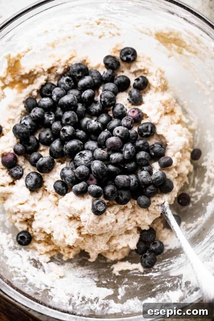 These Blueberry Scones are deliciously moist and easy to make with real, wholesome ingredients. folding blueberries into a batter for blueberry scones