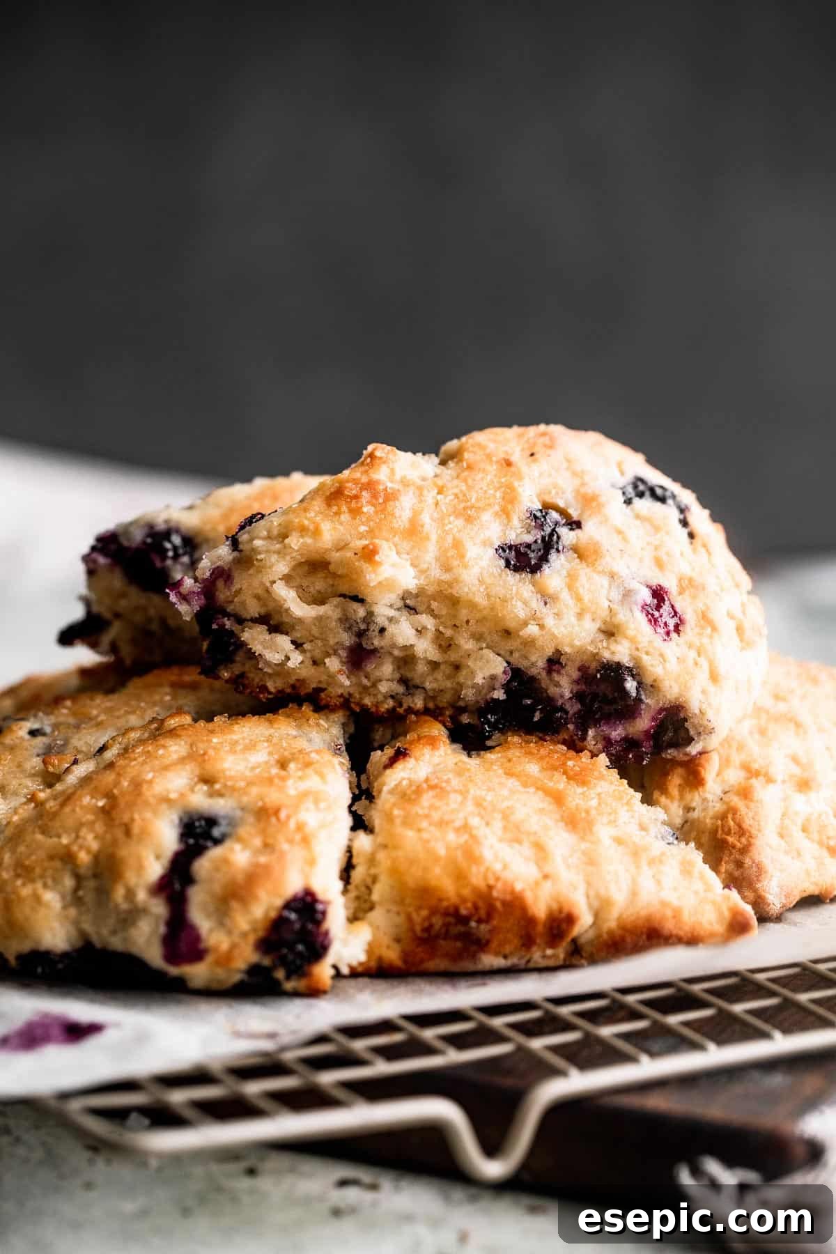 These Blueberry Scones are deliciously moist and easy to make with real, wholesome ingredients. three blueberry scones set on a wire rack