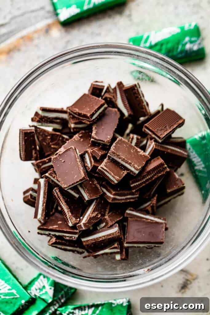 A small glass bowl filled with finely chopped creme de menthe chocolate mints, ready to be incorporated into the cookie dough.
