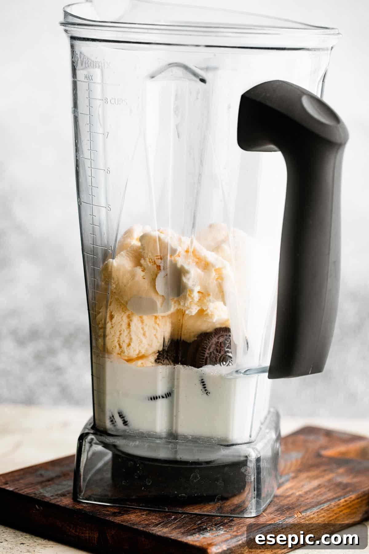 Shamrock Oreo Dream Swirl 4 jar of a blender filled with milk, heavy cream, ice cream, and oreo cookies.