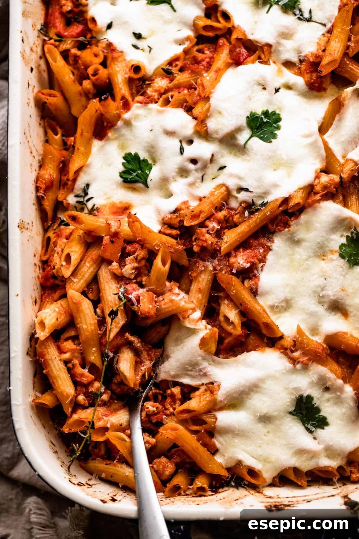 overhead shot of a baking dish with Baked Penne Alla Vodka topped with melted mozzarella cheese.