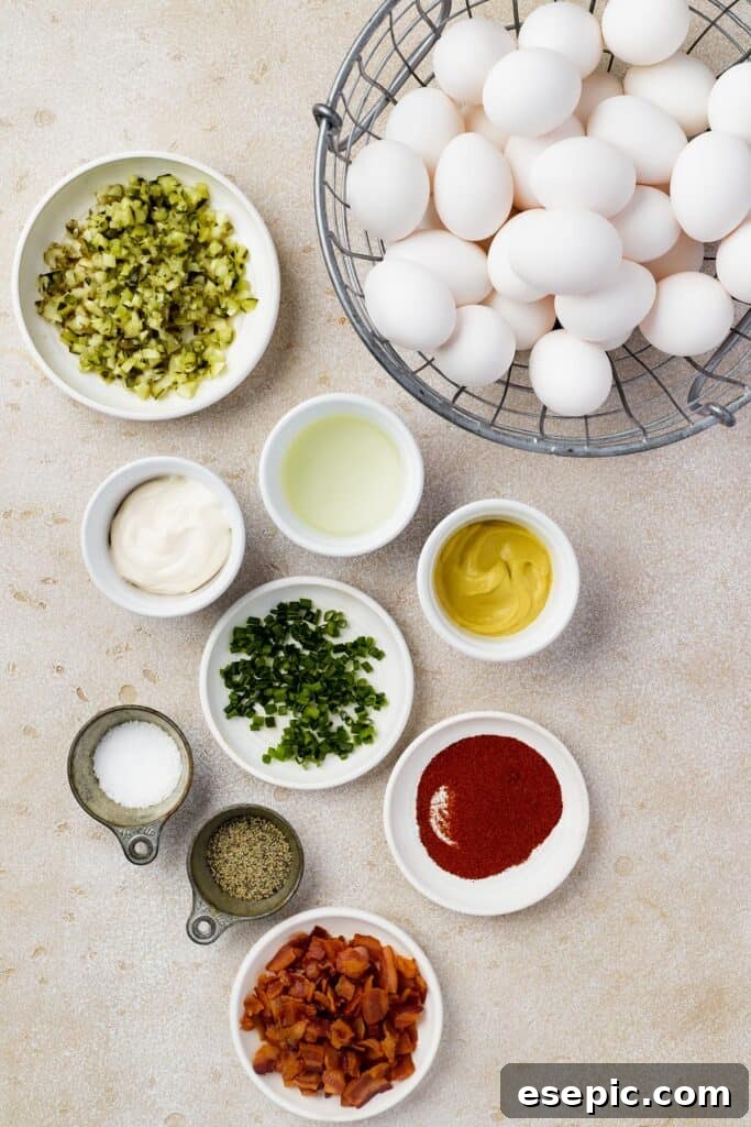From top left: Chopped pickles, eggs, mayonnaise, pickle juice, dijon mustard, chopped chives, paprika, salt, pepper, chopped bacon.