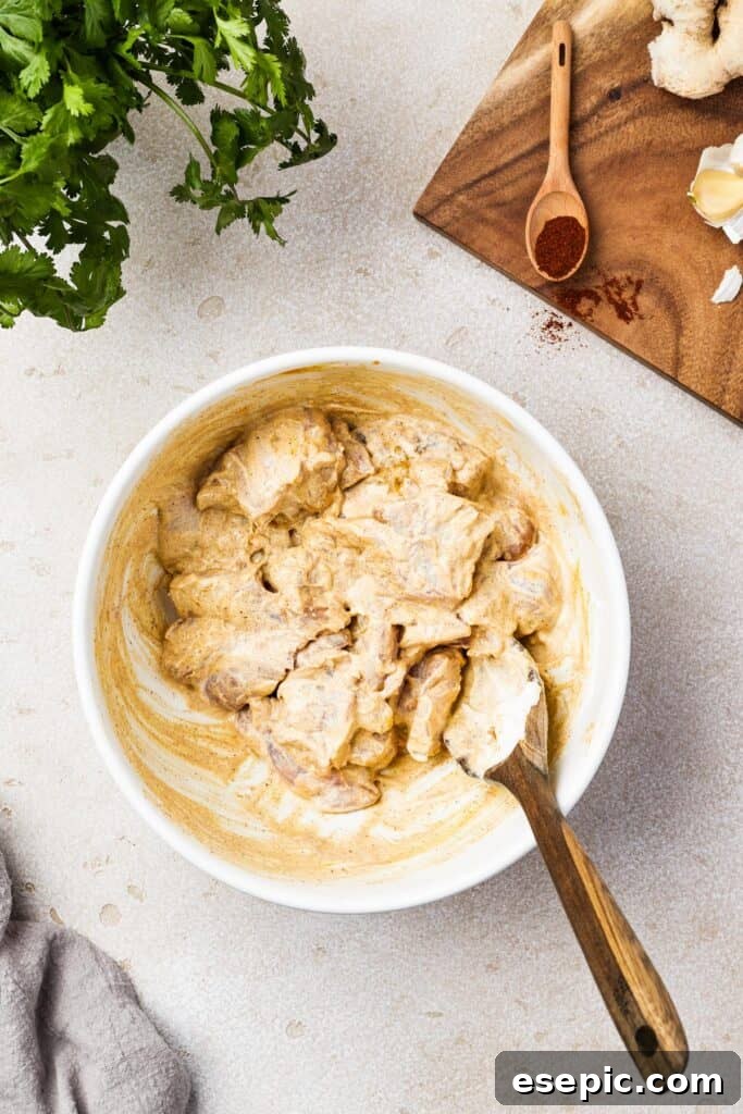 Chicken pieces thoroughly coated in a vibrant, creamy marinade.