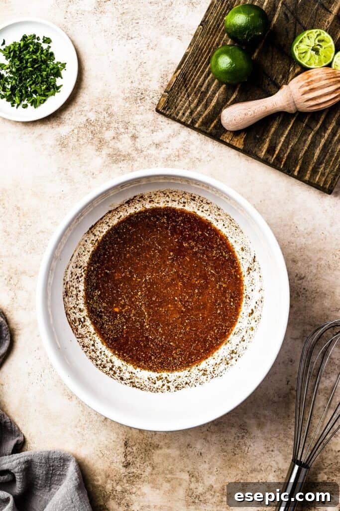 A vibrant citrus and spice mixture prepared in a white bowl.