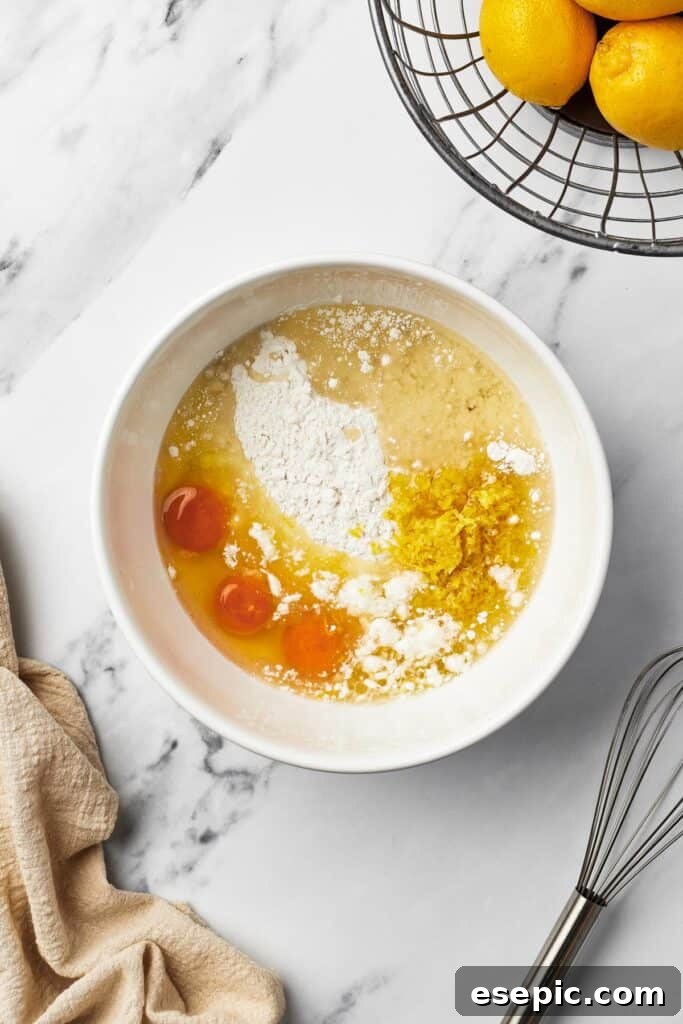 A large mixing bowl containing cake mix, three raw eggs, water, and oil, ready to be combined into a smooth batter.