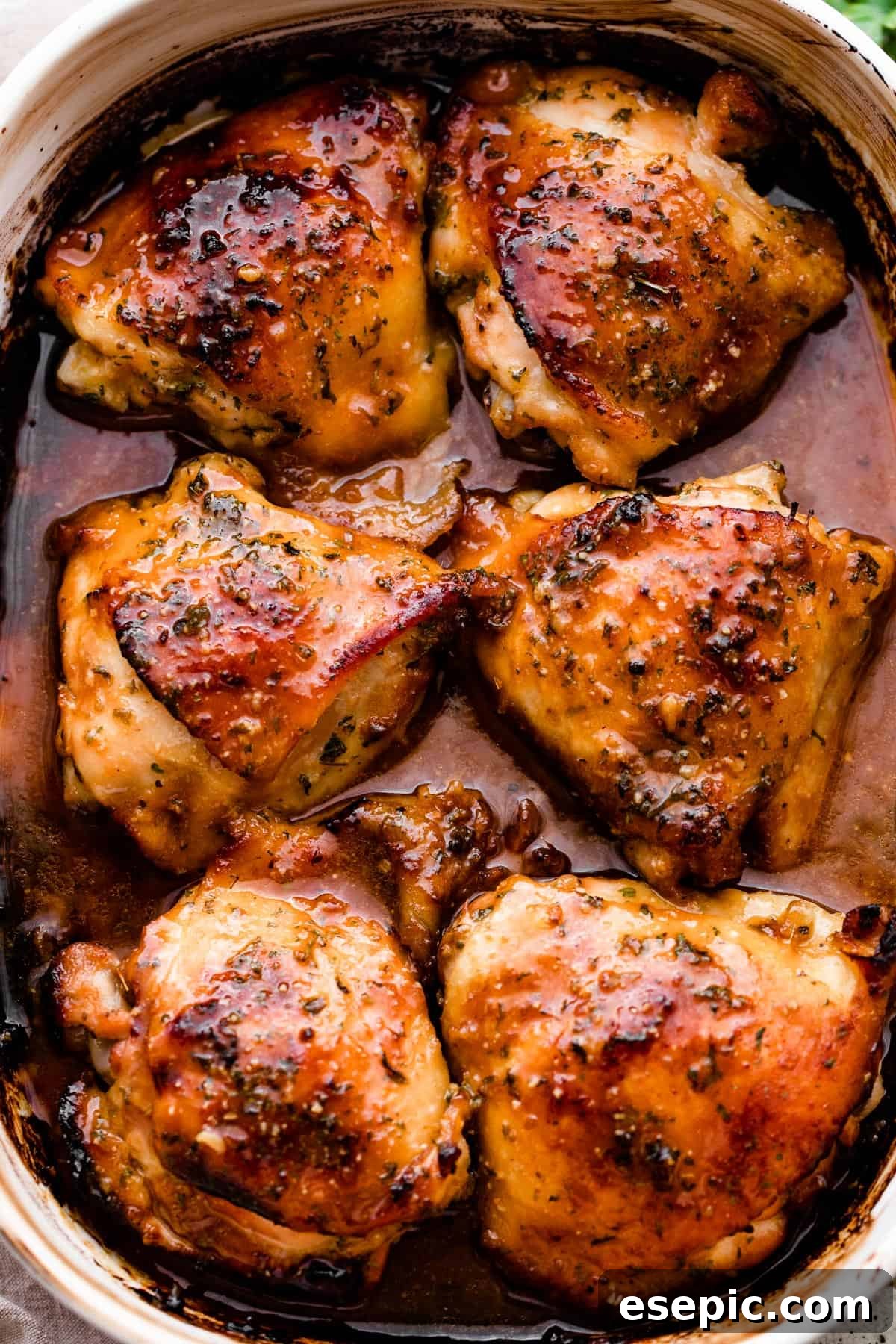 overhead shot of a baking dish with six honey garlic baked chicken thighs.