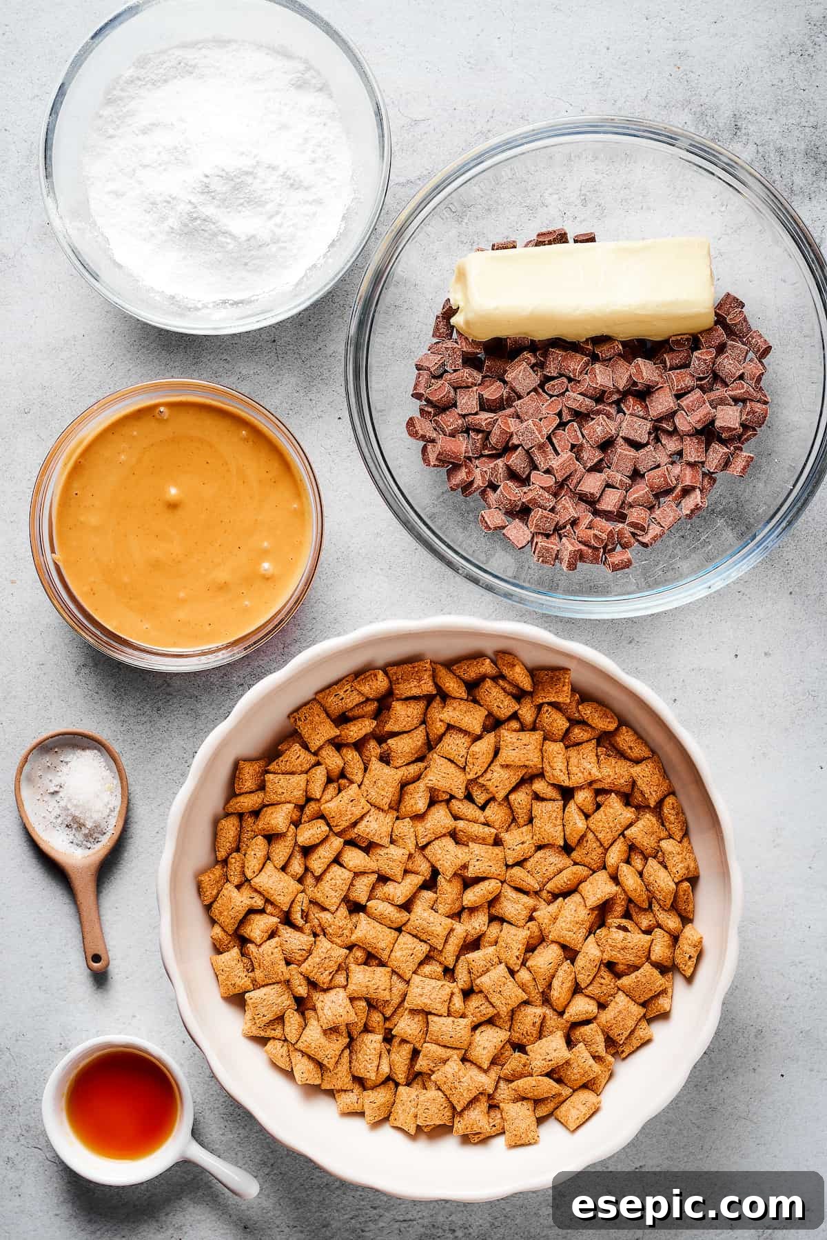 From top left: Powdered sugar, chocolate chunks , a stick of butter, dry Chex cereal, sea salt, peanut butter.