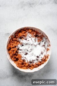 Powdered sugar dumped in a bowl of coated cereal.