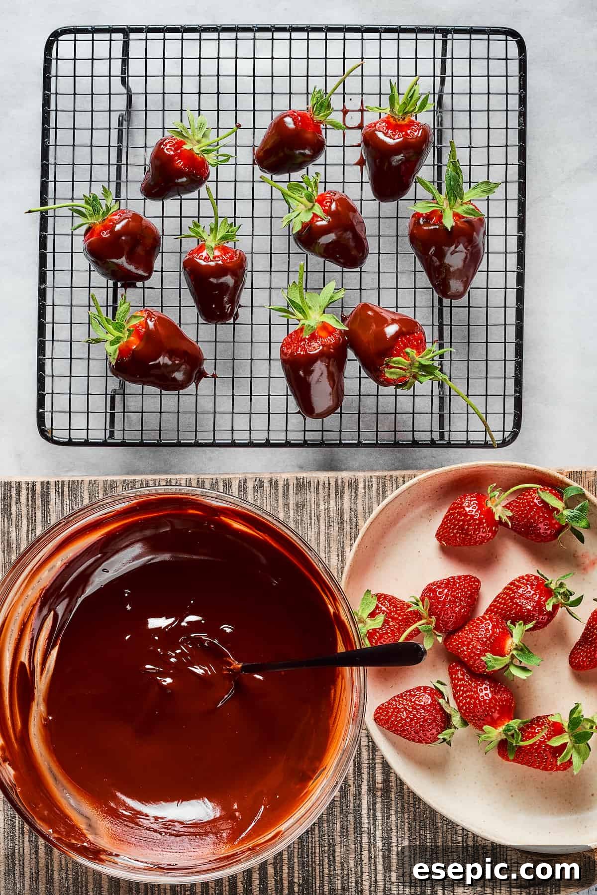 Effortless Chocolate Strawberry Delight 5 An arrangement showing fresh strawberries, a bowl of shimmering melted chocolate, and a wire rack holding several freshly dipped strawberries, allowing the chocolate to set beautifully.