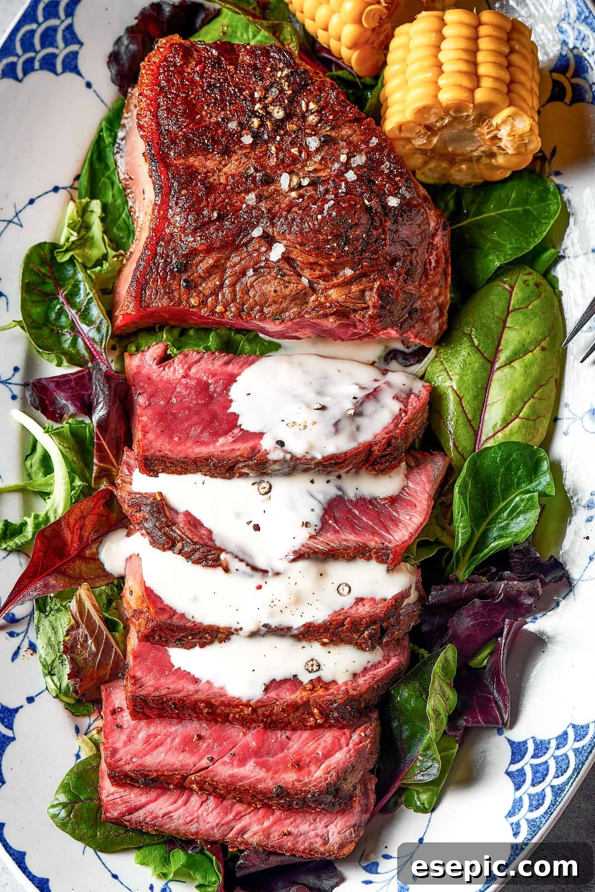 The Ultimate Ultra-Rare Blue Steak: A Steak Lover's Dream at Home Expertly sliced blue steak showcasing its ultra-rare, purplish-red interior and a crisp, seared crust, drizzled with a creamy blue cheese sauce.