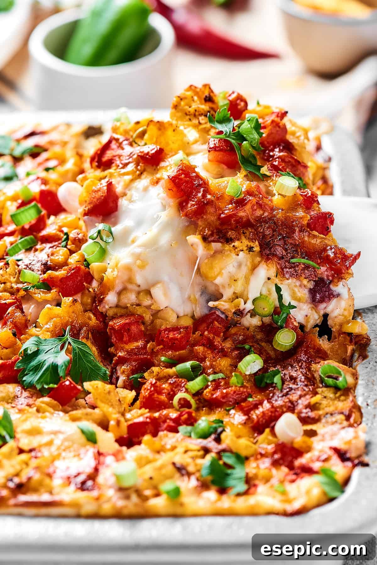 Spicy Fiesta Chicken Bake 4 Close-up shot of a perfect portion of cheesy, bubbly Mexican chicken casserole being lifted out of a baking dish.