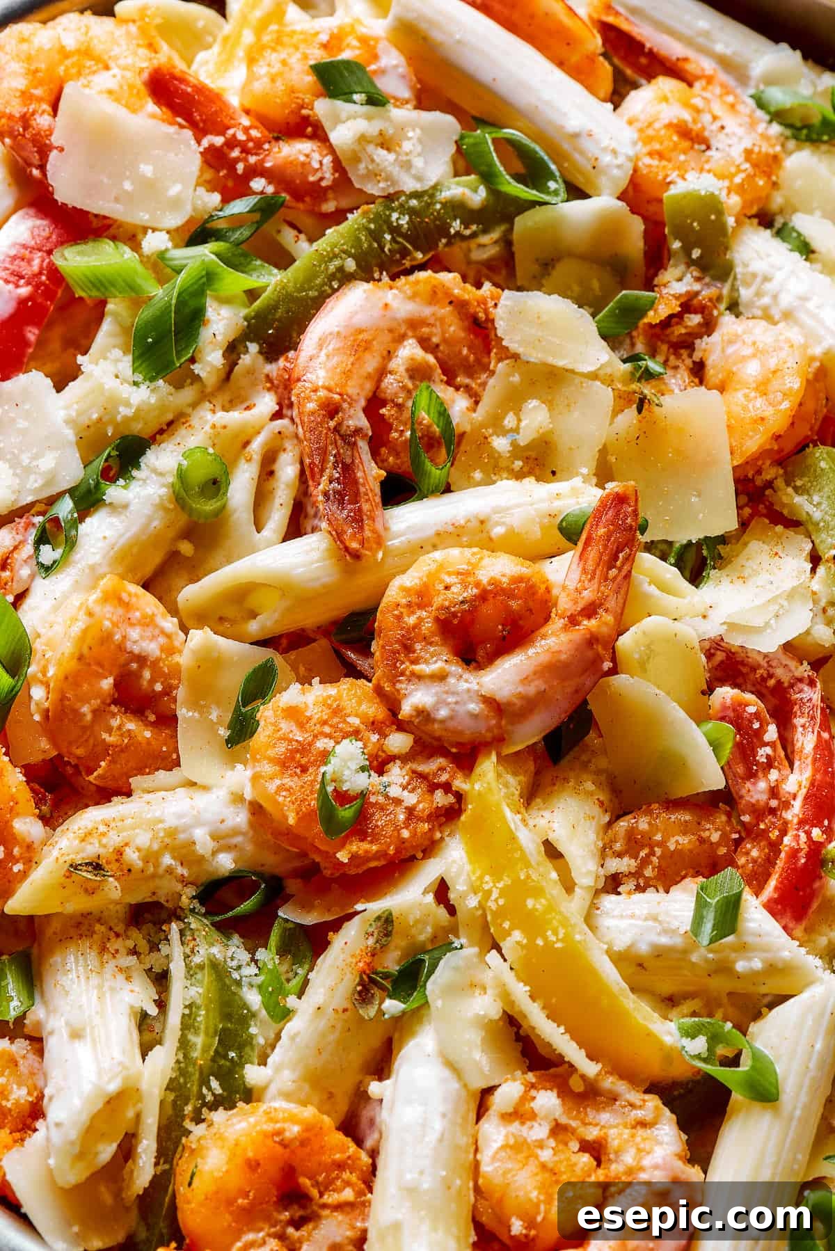 Close-up shot of Rasta pasta, showcasing the vibrant colors of ingredients and the creamy texture of the sauce.
