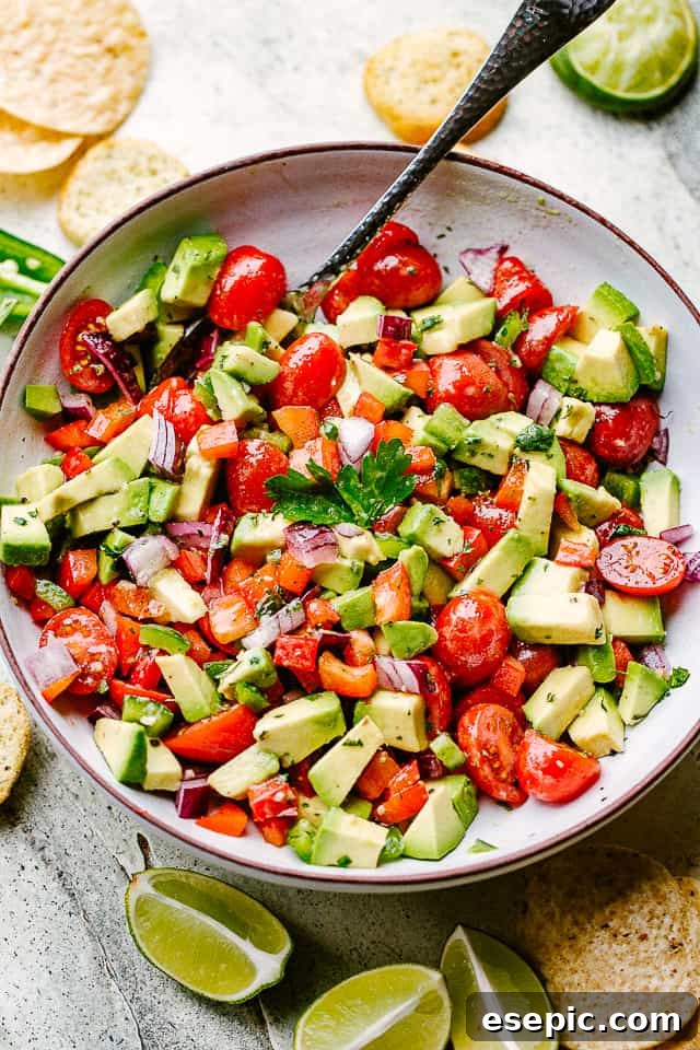 A large bowl of freshly made avocado salsa, showcasing its creamy and chunky texture, ready for serving.
