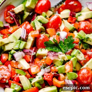 A bowl of avocado salsa, garnished with fresh cilantro.