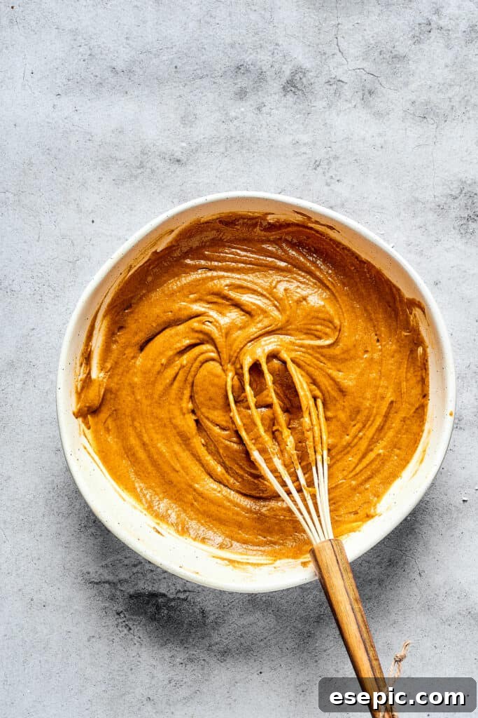 Decadent Pumpkin Cheesecake Muffins 4 Pumpkin muffin batter in a mixing bowl, ready for the cream cheese swirl.