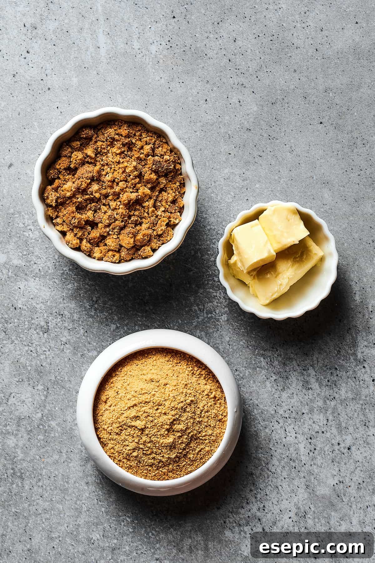 Individual ingredients for the cookie crust: graham cracker crumbs, butter, and brown sugar.