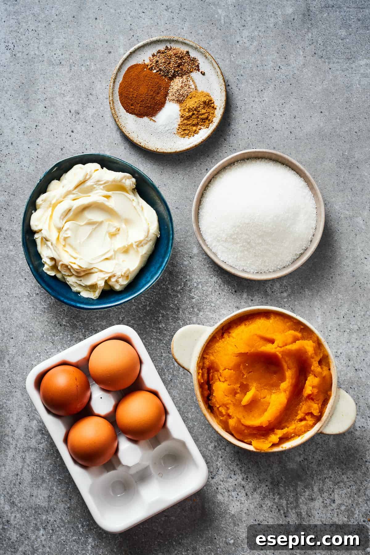 Ingredients for the cheesecake filling: spices, sugar, pumpkin puree, eggs, and cream cheese.