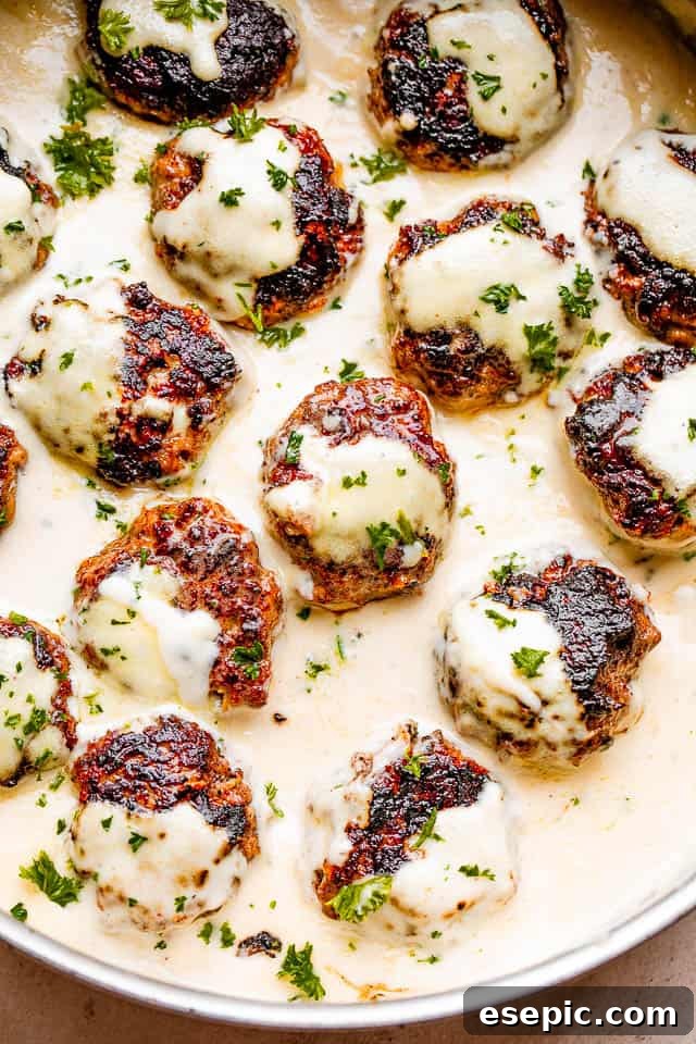 Delicious Swedish meatballs simmering in a rich, creamy gravy, garnished with fresh parsley.