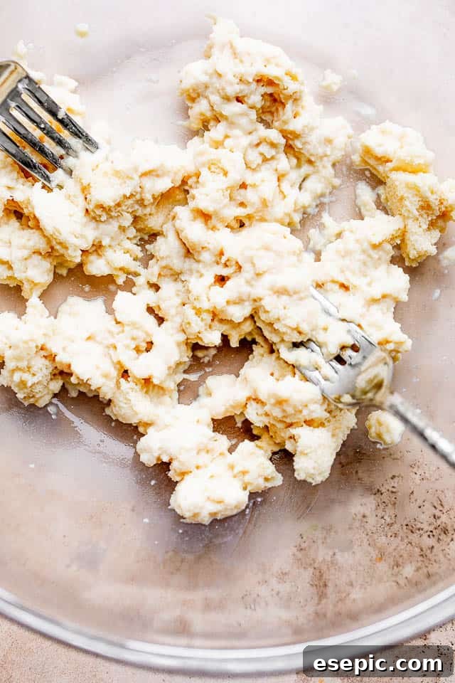 Shredded bread slices soaking in milk, a key step for tender Swedish meatballs.