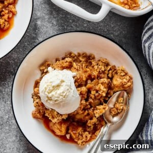 Ice-cream topped apple bake, with an oat topping. A cozy and inviting fall dessert.