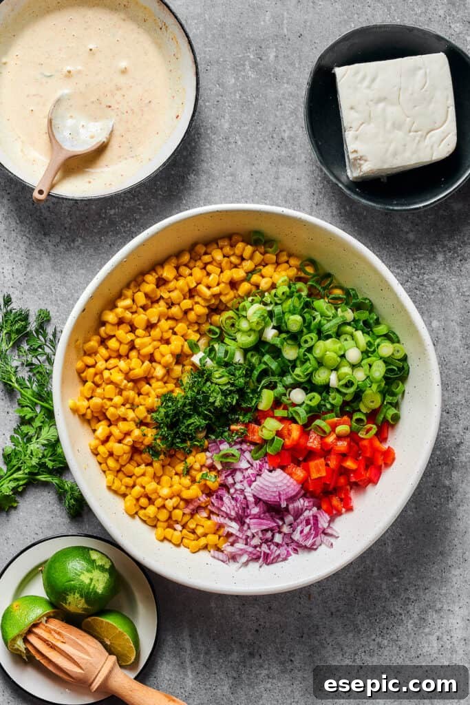 Creamy Mexican Street Corn Salad 4 Elote salad ingredients in a bowl.