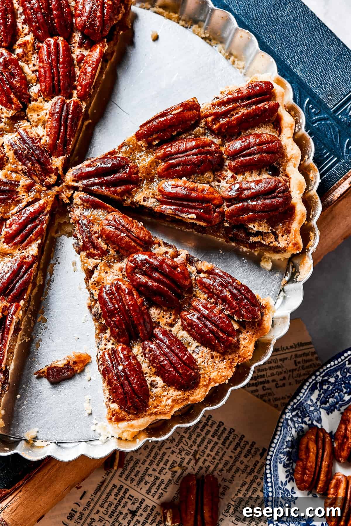 A pie dish with several slices of golden-brown pecan pie remaining, revealing the gooey filling and crunchy nuts, with a perfect crust.