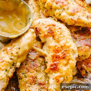A close-up photo of chicken tenders and a small serving bowl filled with mustard sauce.