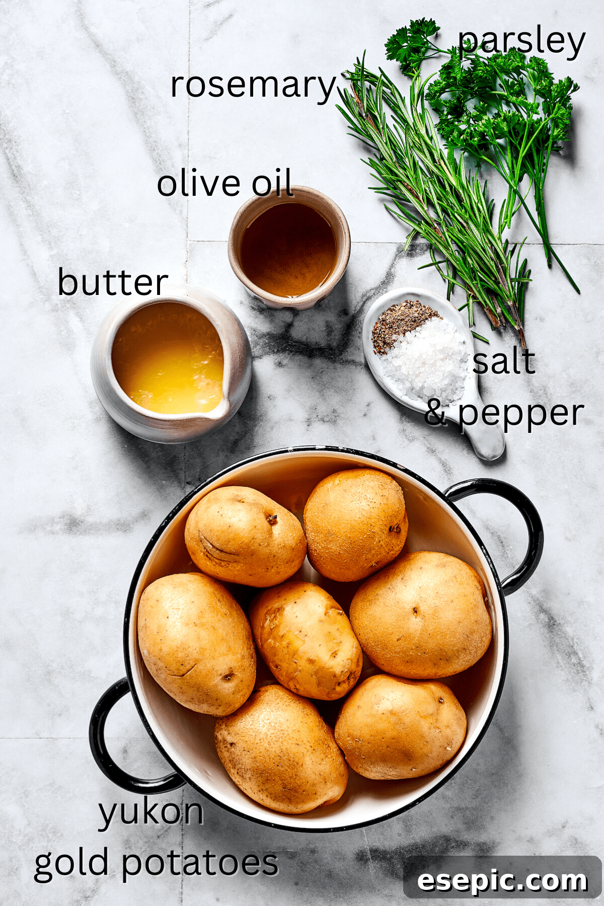 From top: Fresh herbs, olive oil, melted butter, salt and pepper, and cut-up potatoes, laid out as ingredients.