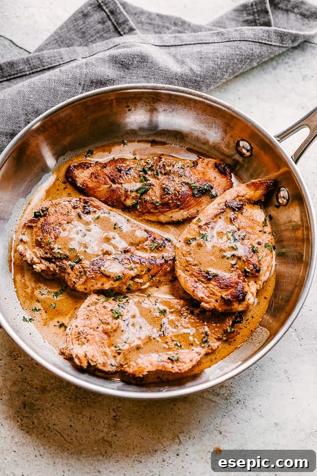 Enjoy our go-to stovetop recipe for juicy and tender balsamic chicken breasts, easily made in one pan in just 30 minutes! top view of four chicken breasts in a skillet with creamy balsamic sauce