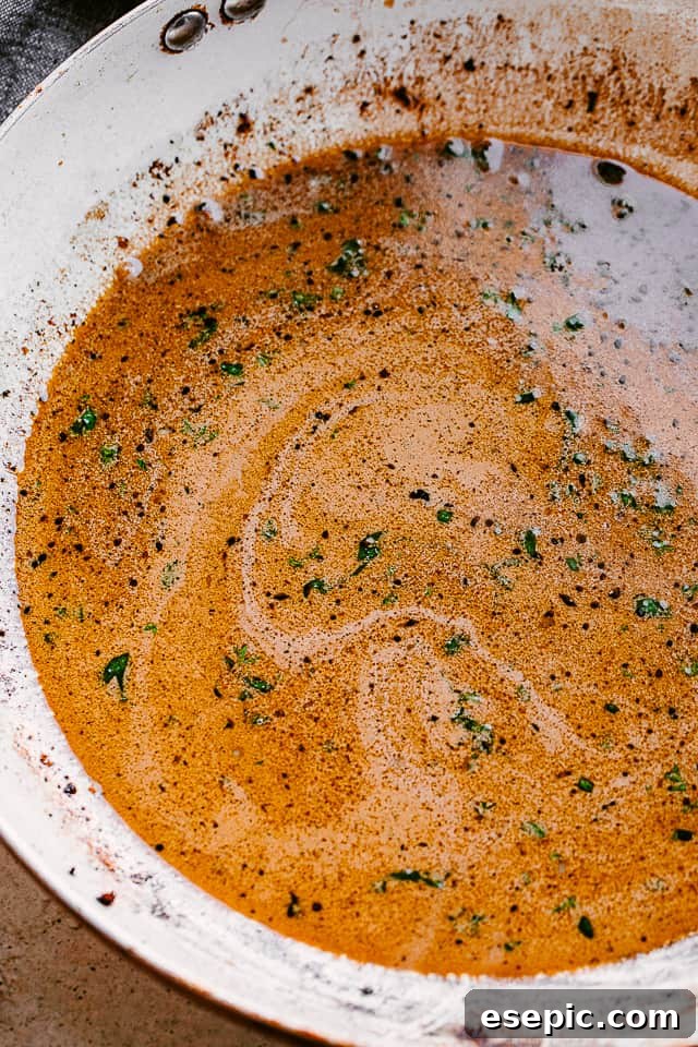 Enjoy our go-to stovetop recipe for juicy and tender balsamic chicken breasts, easily made in one pan in just 30 minutes! balsamic sauce cooking in a skillet