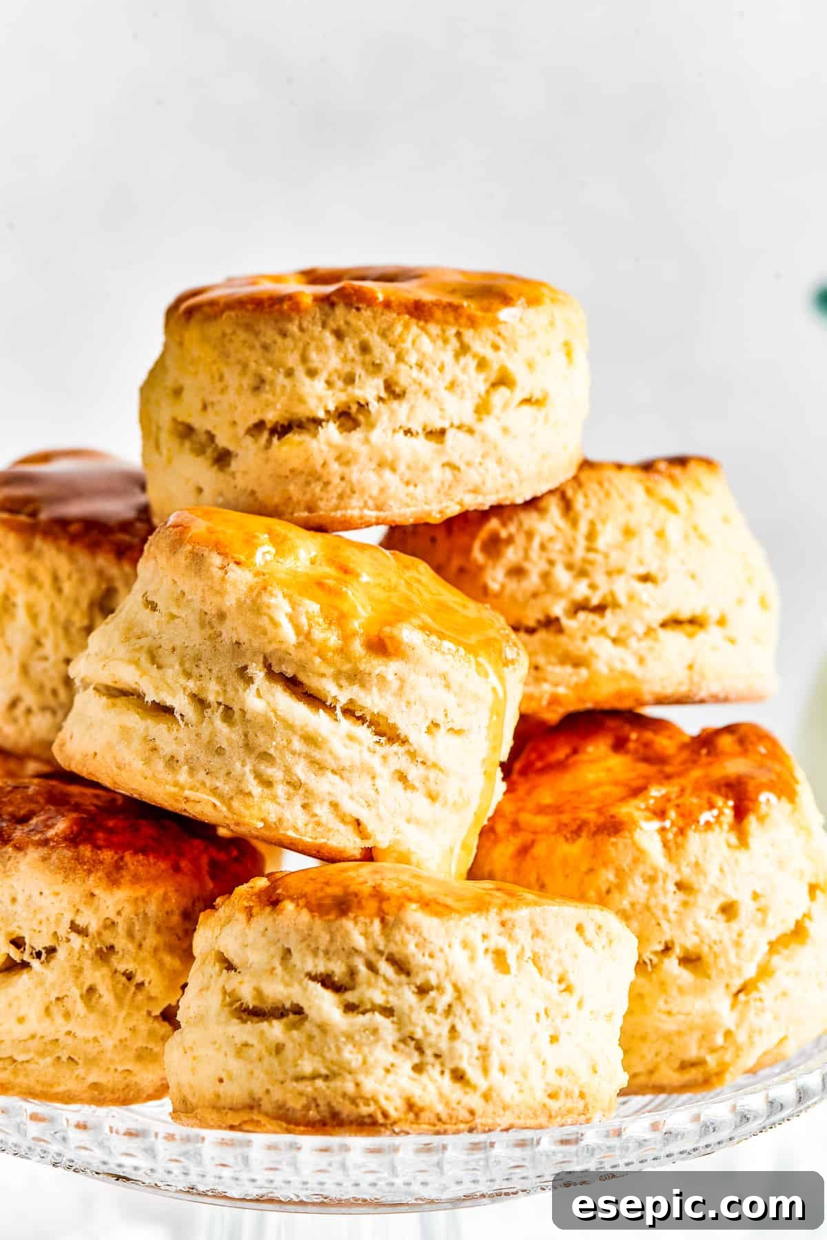 Six biscuits, stacked in a pyramid shape on a cake plate.