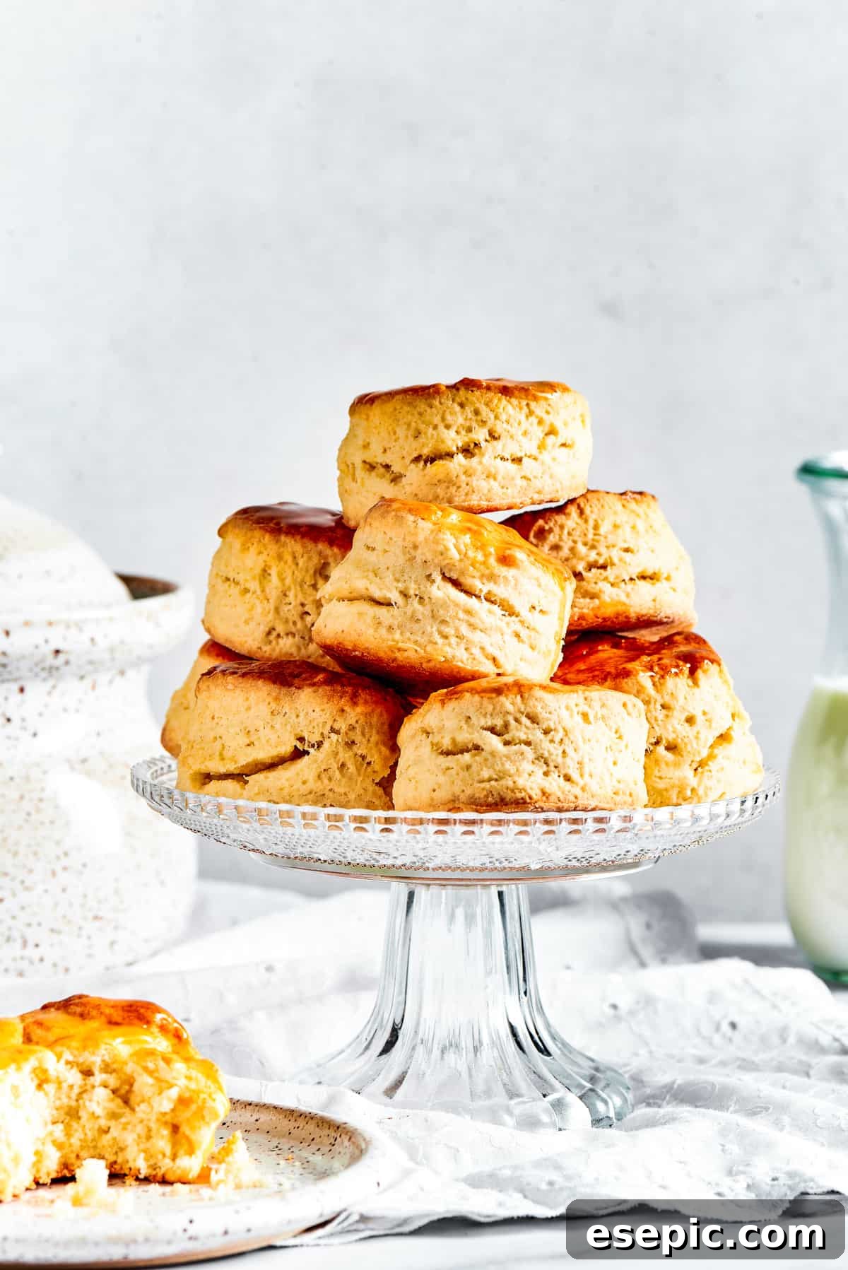 Biscuits on a cake stand, with one biscuit placed on a saucer.