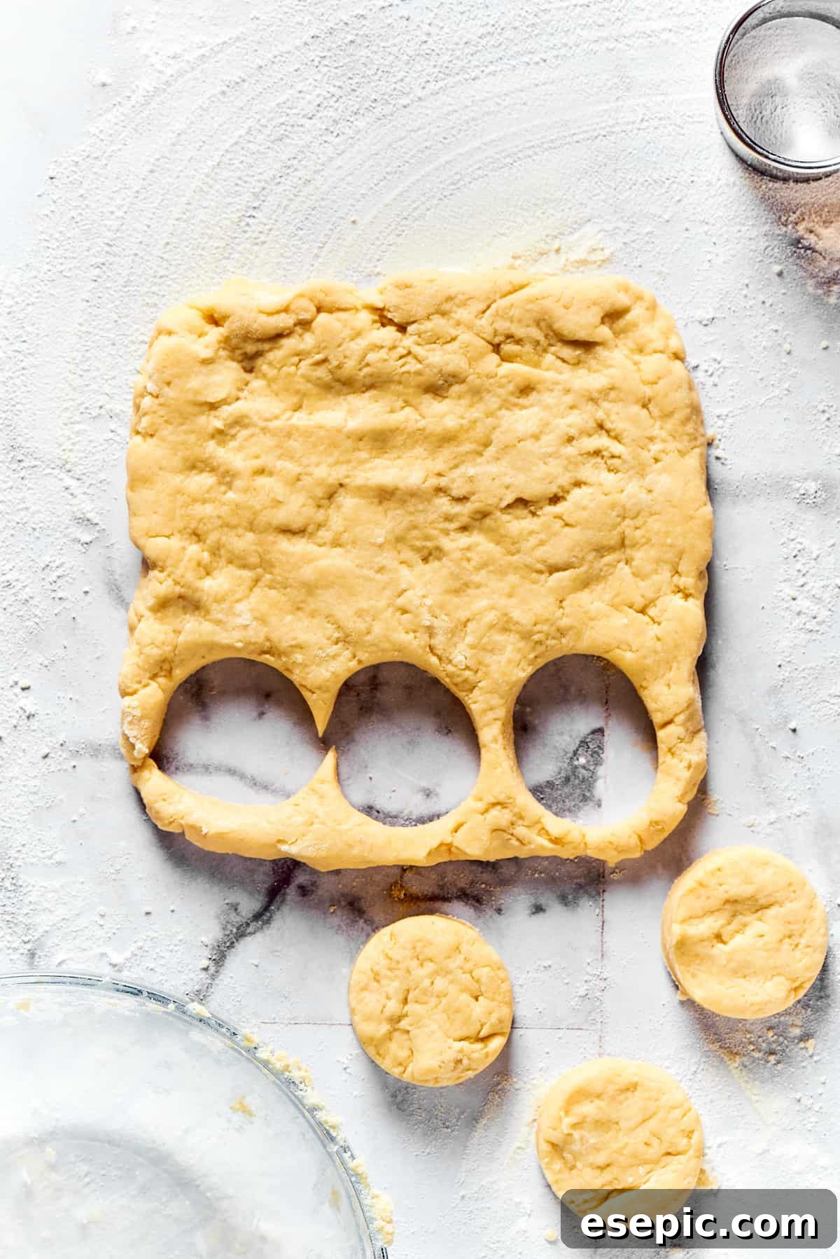 Cutting biscuits out of dough.