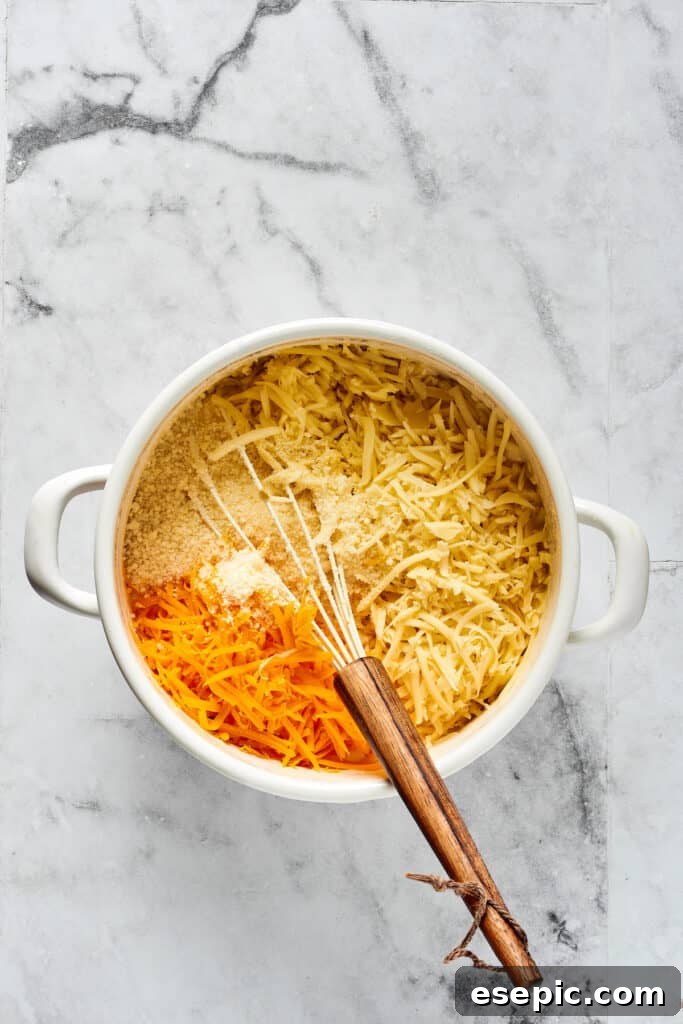 Stirring cheese and seasonings into a cream sauce.