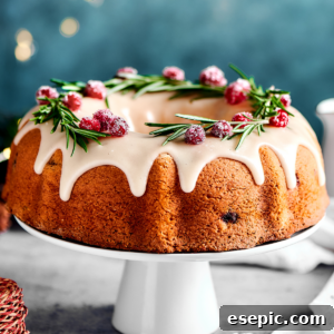 cranberry cake on a white cake stand, with lights in the background of the shot.