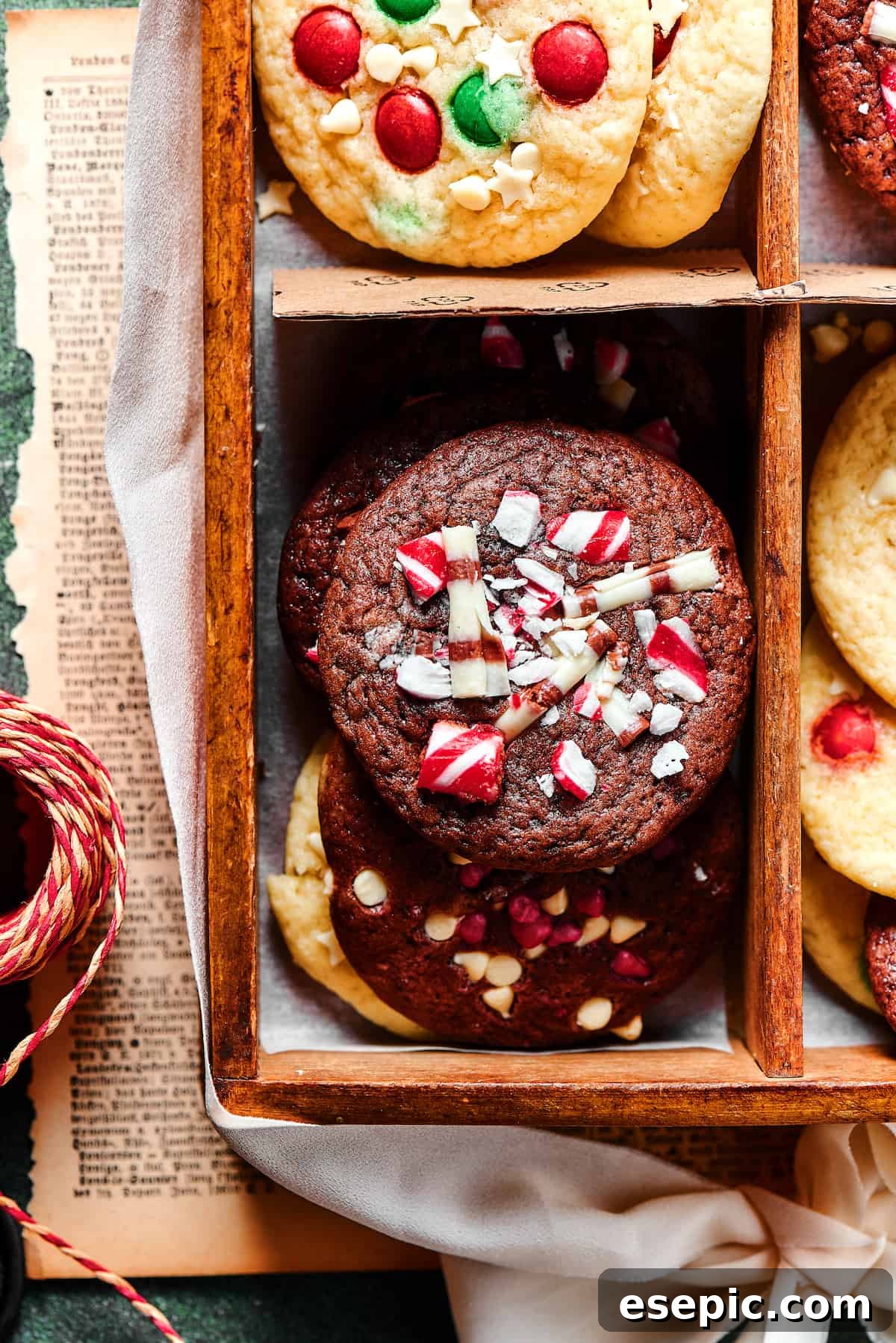 Easy vanilla and chocolate Christmas Cake Mix Cookies are studded with red and green M&Ms, and decorated with even more holiday goodies! A close-up view of baked chocolate Christmas cake mix cookies, beautifully adorned with festive crushed peppermint pieces, ready to be enjoyed.