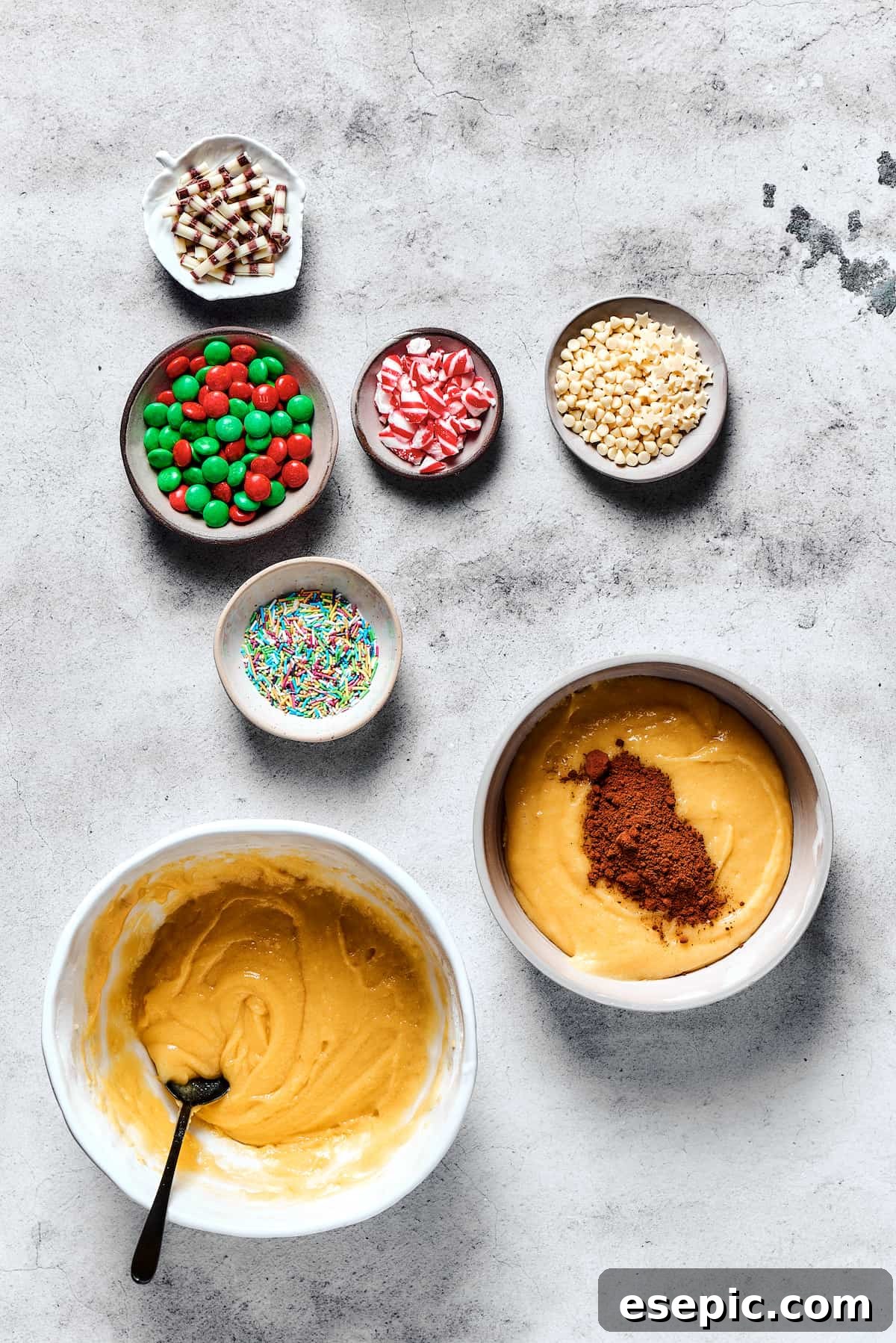 Yuletide Cake Mix Wonders 5 A close-up shot showing cocoa powder being gently folded into one of two bowls of cookie dough, transforming it into a rich chocolate flavor.
