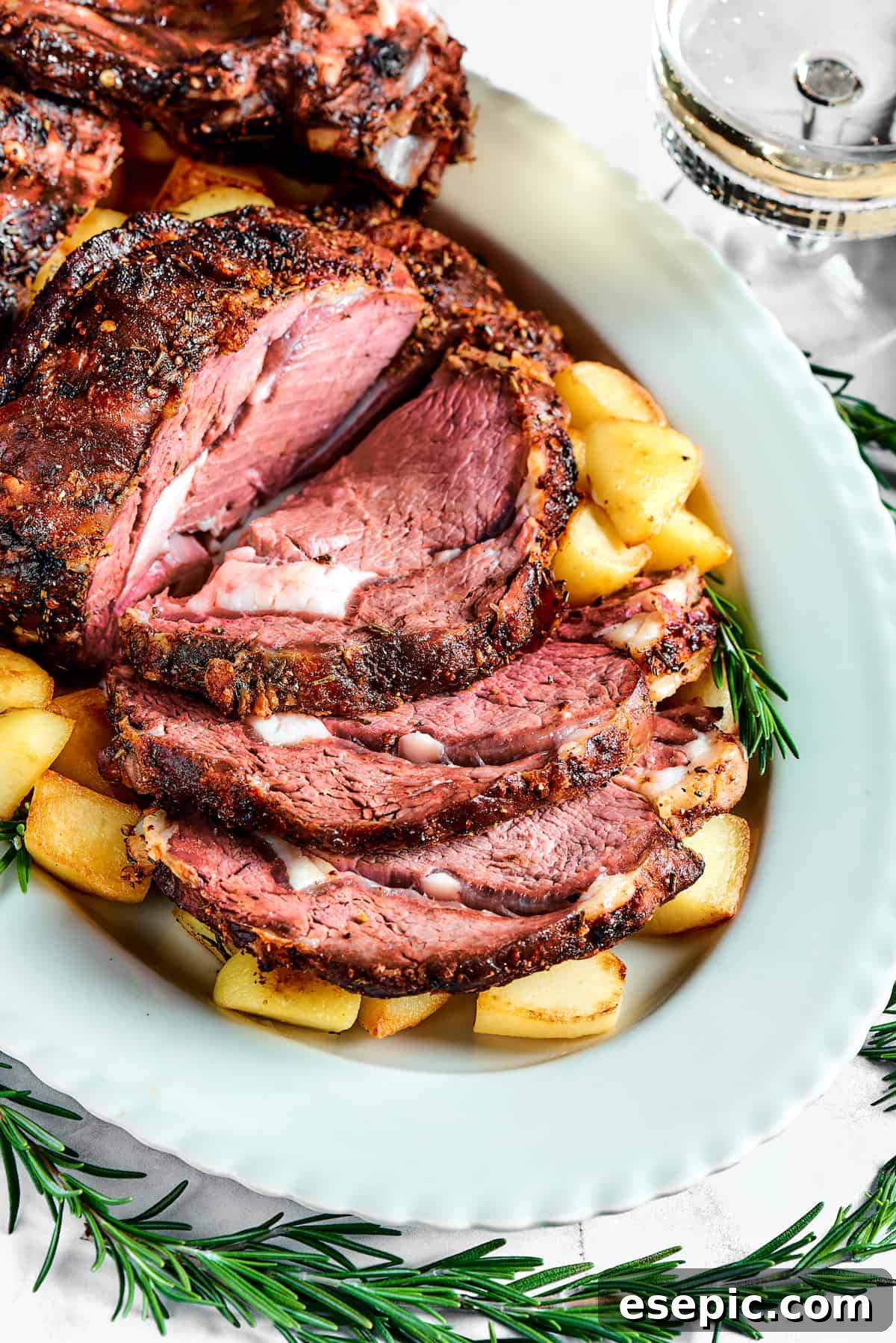 A platter showcasing a perfectly sliced prime rib roast, revealing its desirable pink interior.