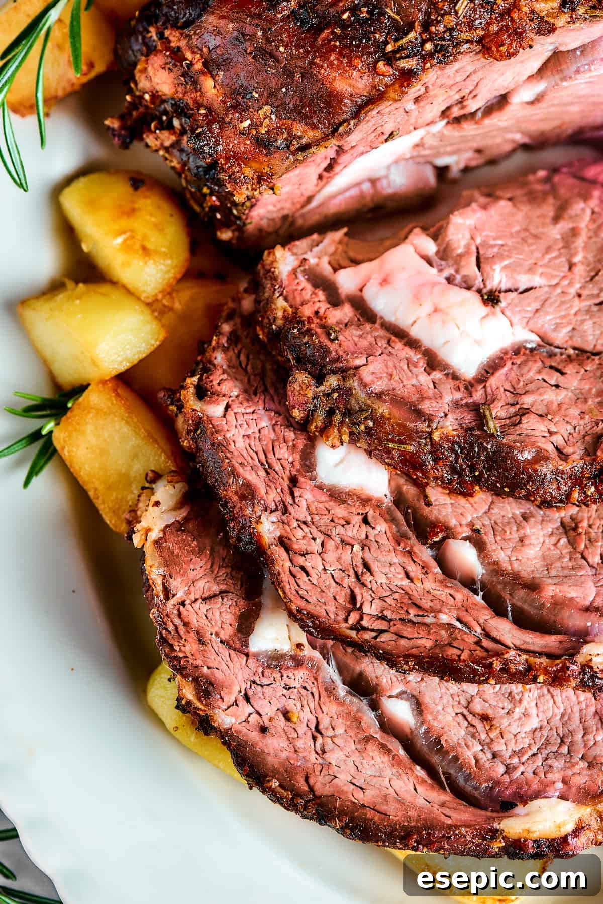 Close-up of medium-rare sliced rib roast, showcasing its perfect doneness and juicy texture.