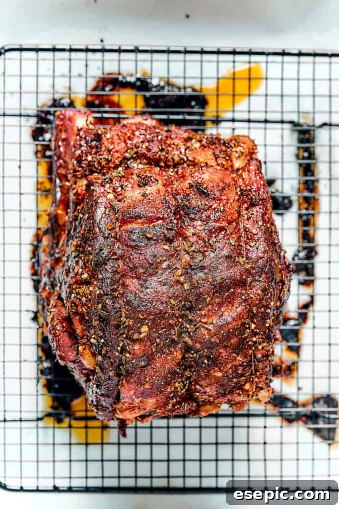 A beautifully roasted prime rib resting on a wire rack after its high-heat sear.